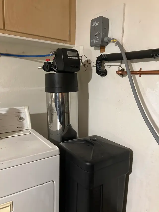 Water softener and brine tank set in a laundry closet